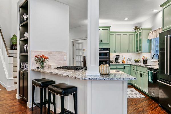 The built-in is now more glamorous with black lacquer and accent lighting, modified kitchen layout with artisan tiles and granite countertop