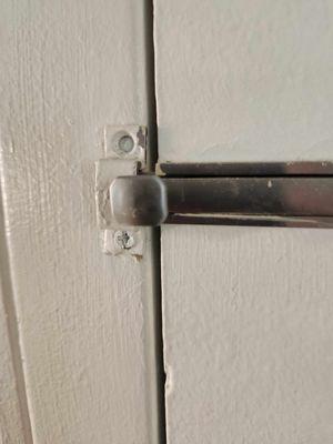 Door lock not secured to adjoining room door.