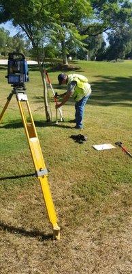 Setting iron pipes for a boundary retracement in long beach for Virginia Country club.