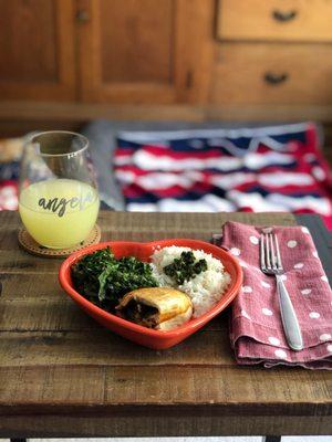 Rice, sautéed greens, veggie empanada