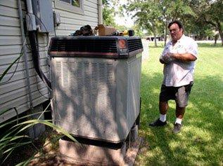 Larry performs a Spring Planned Service Agreement check-up on a condenser.