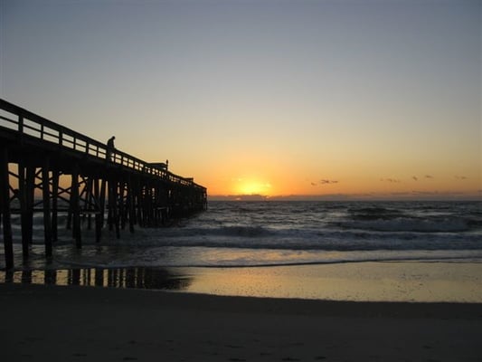 Sun rises over the pier at Amelia By the Sea Condos