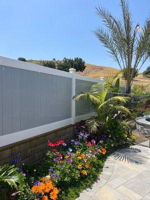 6 foot 2 tone vinyl fence.  White ride lines and grey panels.