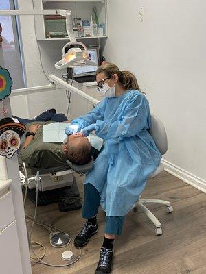 Our hygienist Olga making sure her patient leaves with  shiny clean teeth!