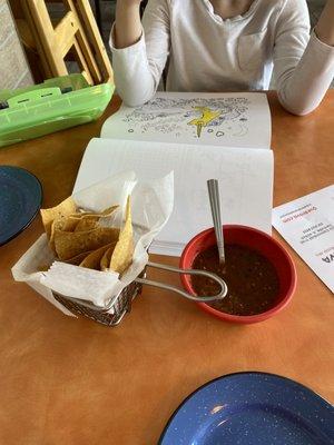 Fresh hot chips and salsa served on the table when you're seated.