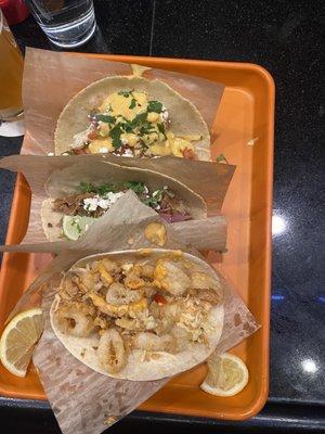 From the top, the Nashville chicken, carnitas and calamari tacos