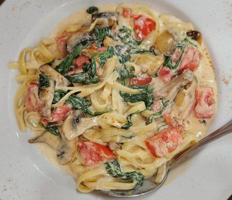 Fettuccine with Fresh Tomatoes, Spinach and Mushrooms in a cream sauce with a touch of Old Bay.