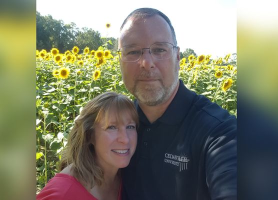 Larry Reeder and Susan in sunflower field