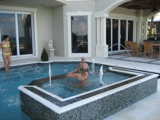 This beach front home has a swimming pool that doubles as a beautiful fountain from inside the house.