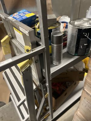 Ladder cart next to the meat cooler, contains paint used to hide evidence of contamination