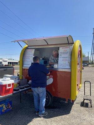 My husband, ordering food at the cute hot-dog wagon.