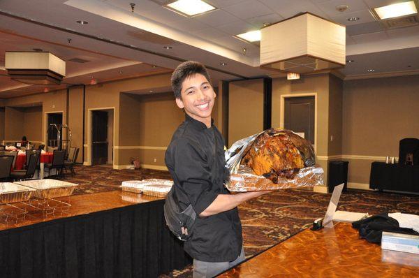 Helping out for the Filipino Nurse Association. Carving Roast Pig.