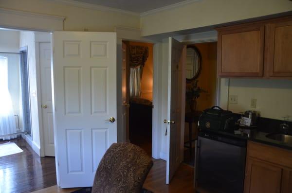 view into smaller bedroom and door to suite.