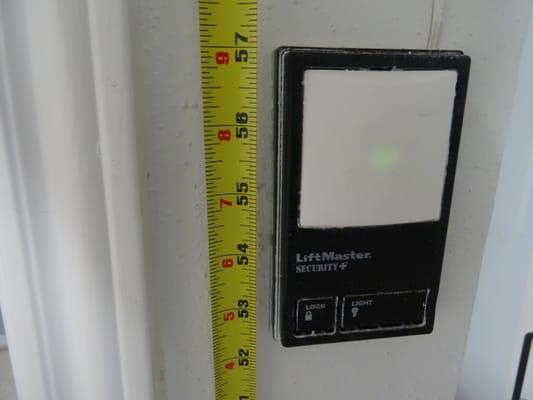 Garage door operator button too low. Child safety code.