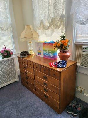 The bedroom has lots of storage here in the bureau drawer and a closet.