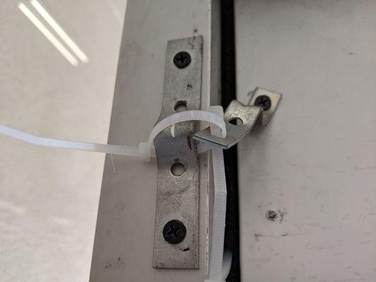 Emergency exit is locked with a zip-tie. The management of this location must care more of money than your safety or the fire code.