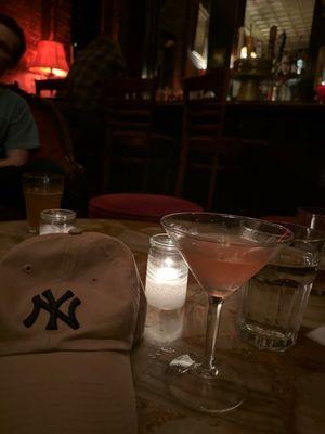 An Orange Cosmo and a New York yankee hat