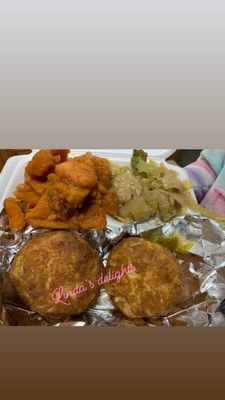 Two crab cakes with a side of cabbage & some candy yams