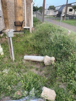 Tall grass, junk laying around