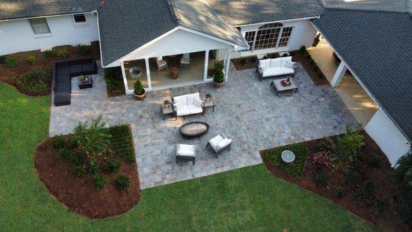 Backyard retreat with a patio, fire pit, landscape lighting and