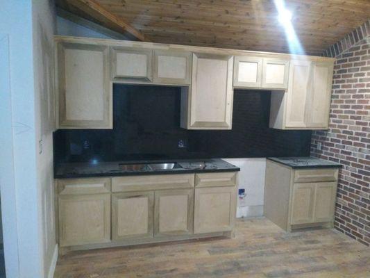 Finish cabinets with black galaxy full backsplash Countertops