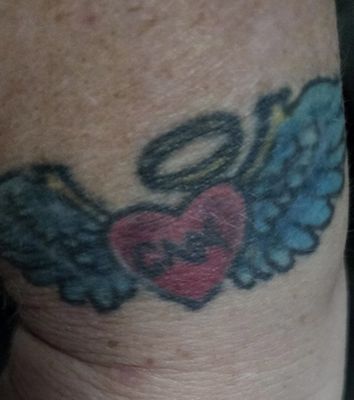 This is my angel wings for doing hospice work ,some of the black outline is missing and the letters all run together