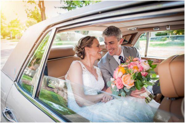 A moment photographed  between a bride and groom before leaving the church after they are married.