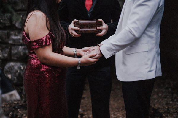 The bride and groom's hands joined together in ceremony