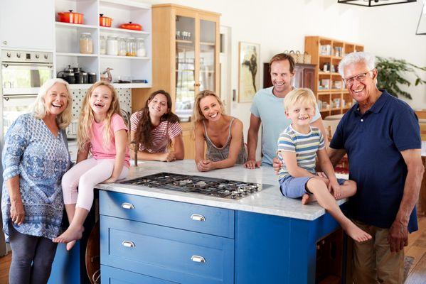 Family hanging around a painted kitchen in Arcadia Lakes