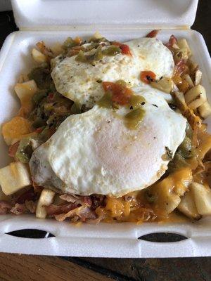 Breakfast skillet with green chili and 2 eggs over easy.