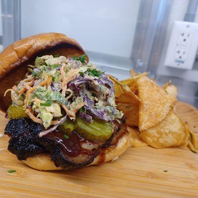 Bourbon Wood Smoked Brisket, Homemade BBQ Sauce, with Brussels Sprout Slaw in a Honey Mustard Dressing. B&B Pickles