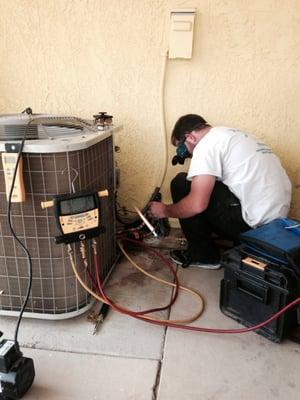 Our technician performing A Refrigerant Leak Repair