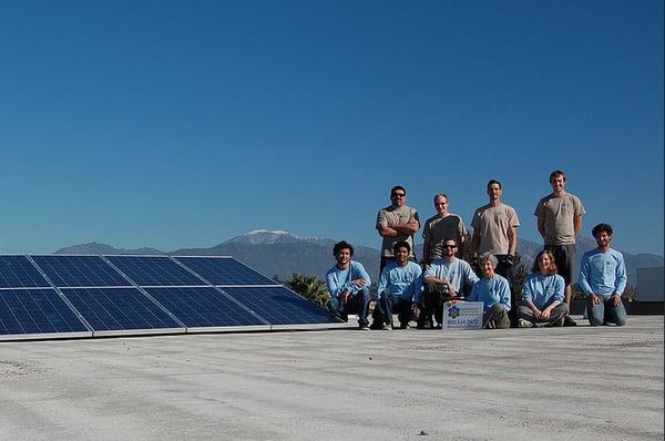 The crew next to a PV system