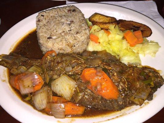 Brown stew fish (snapper) with rice and peas, veggies, and plantain! Try it!