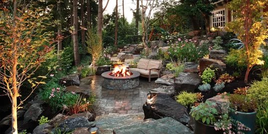 Excellent use of natural stone/boulders with paver hardscaping, also beautifully executed terracing design.Very private niche to entertain.