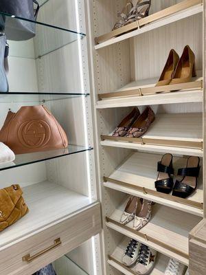 Glass shelving, integrated lighting and angled shoe shelves with shoe fences.  We can create the closet of your dreams.