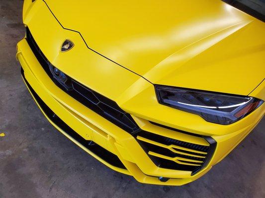 Lamborghini Urus total transformation from glossy black paint to Satin Yellow. All surfaces wrapped in and out!