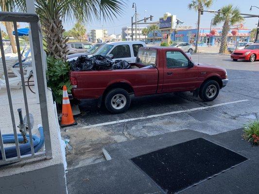 Opening the front door (truck parked in same spot with trash our entire stay)