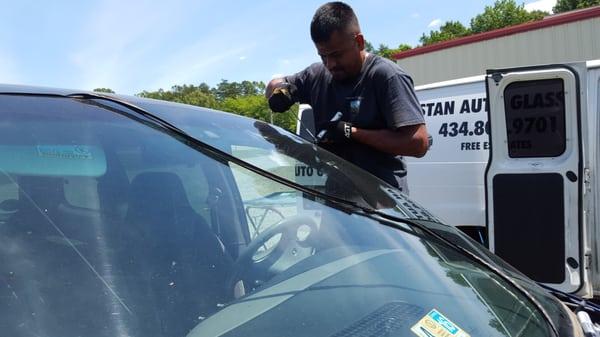 Tristan removing the seal that holds the glass to the van.