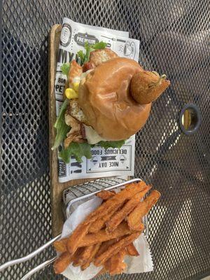 Grilled Chicken and Bacon Sandwich top with some kind of Fried Cheese Ball with Sweet Potato Fries