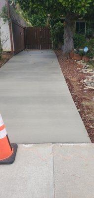 Finished Concrete on right side of new driveway