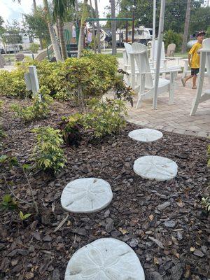 Sand dollar stepping stones to outdoor patio and playground area.