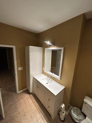 New vanity, faucet, mirror, and linen closet installed.