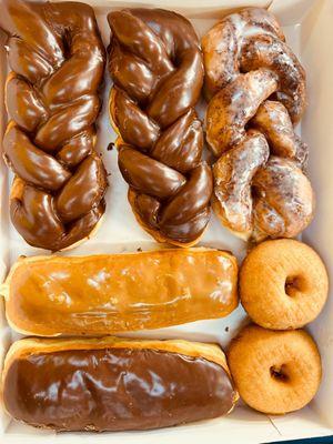 Chocolate twist, glazed twist, maple bar, chocolate bar, and plain cake donuts