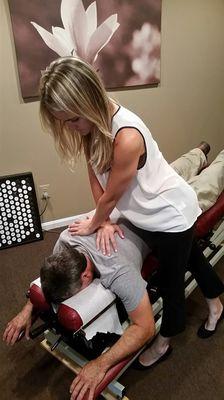 A patient receiving a gentle adjustment for upper back and neck pain.