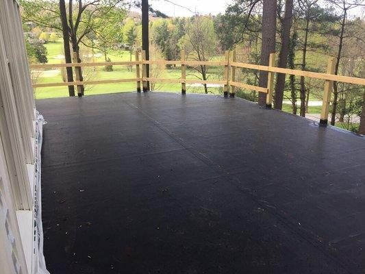 Fully adhered EPDM roof on a walkout porch protects the lower level patio space.