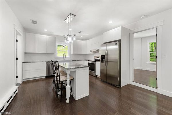 Modern all white kitchen with island bar, granite counter tops