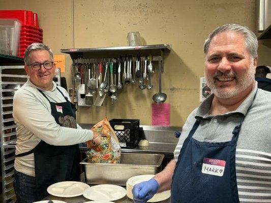 Mark helping prepare meals at a food kitchen.