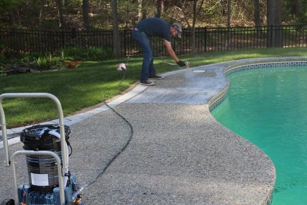 Pebble tech pool patio sealant application. Semi gloss.