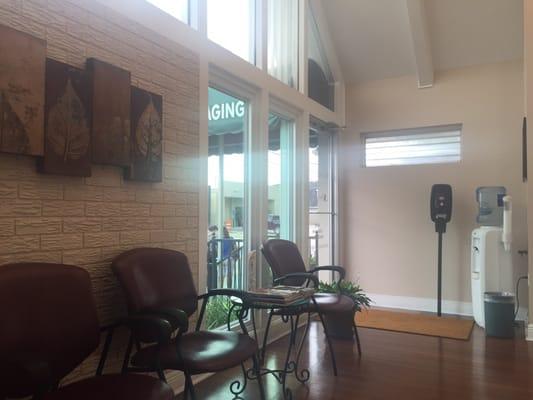 Lobby with high ceilings! They have a hand sanitizer machine, water cooler, tv and tons of magazines!